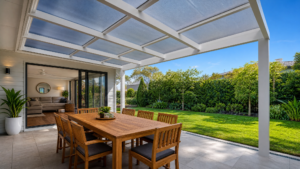 patio installed over with a dining table below and a lawn view