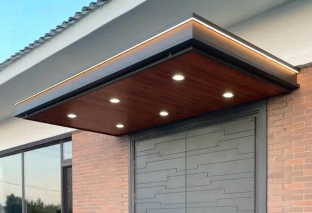 Wall-mounted aluminium box canopy with timber-look ceiling, LED downlights and perimeter light strip above a front entrance
