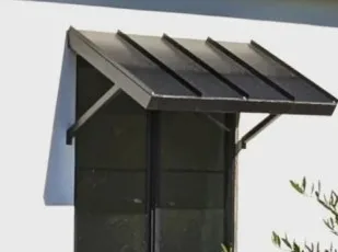 Standing seam aluminium awning seen from the side showing the folded roof seams